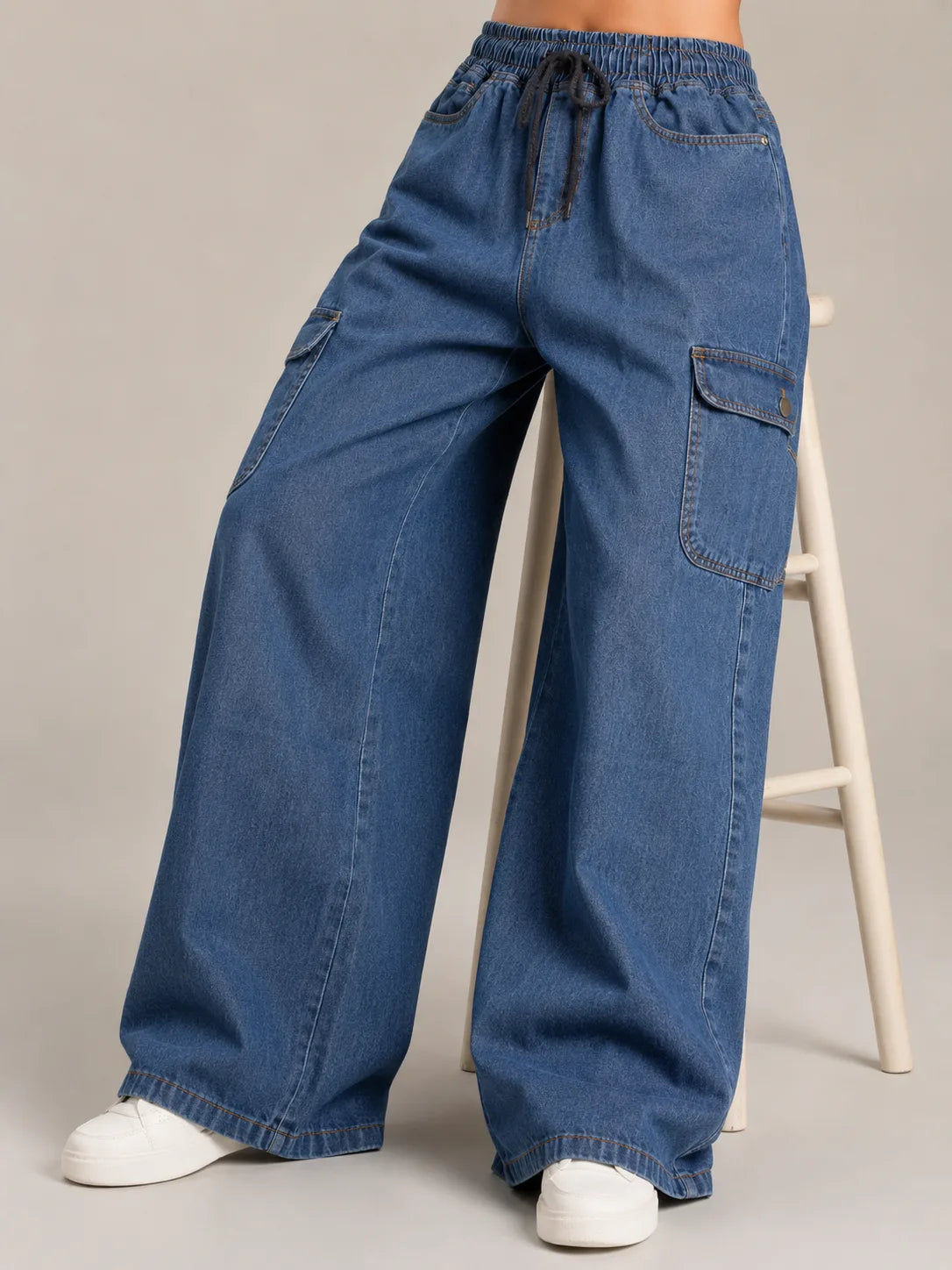 Medium blue baggy cargo jeans for girls front view