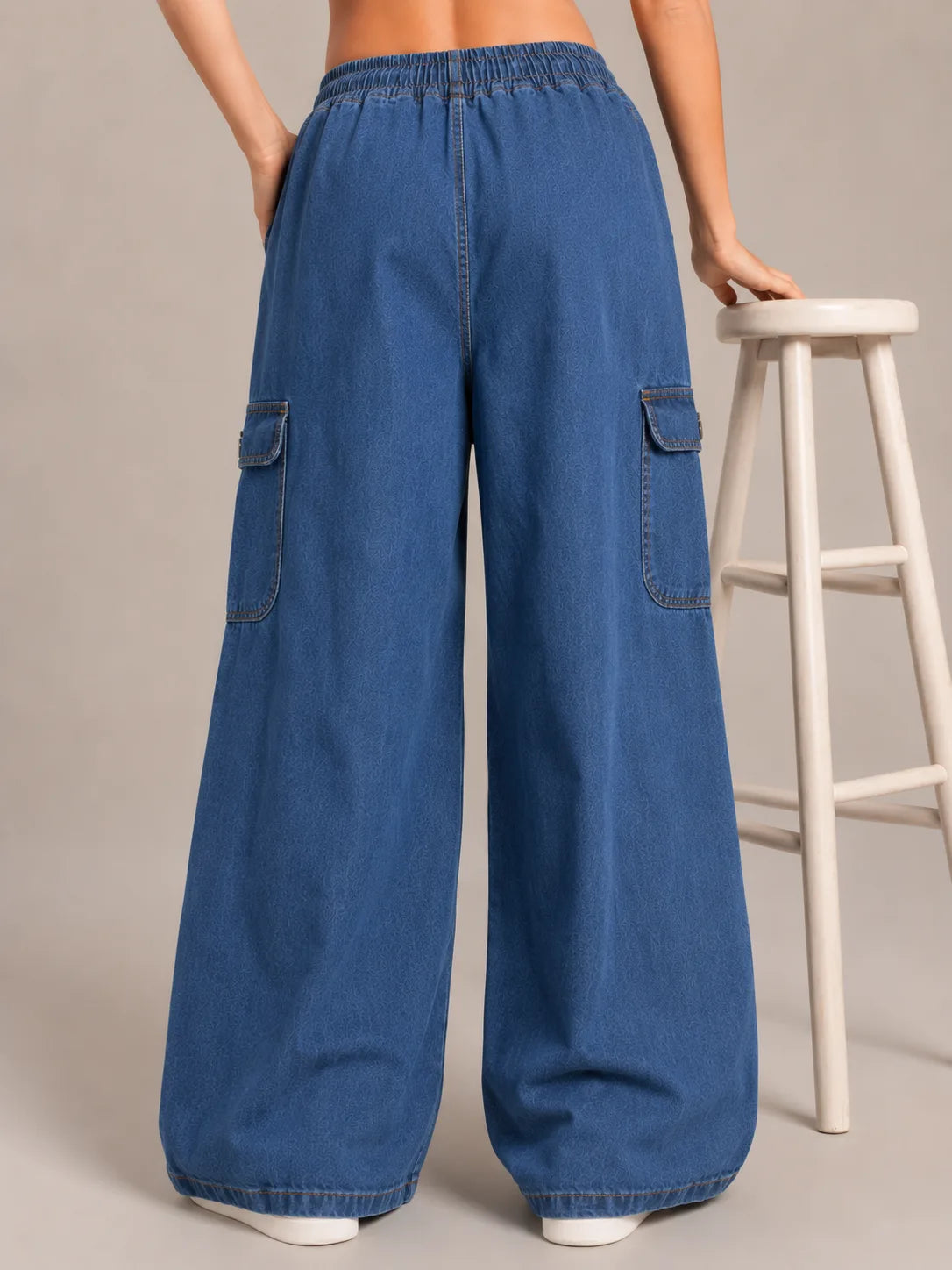 Medium blue baggy cargo jeans for girls back view